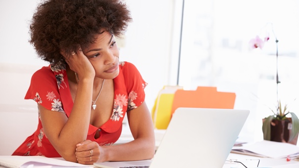 Frustrated Woman Working At Desk thinking about